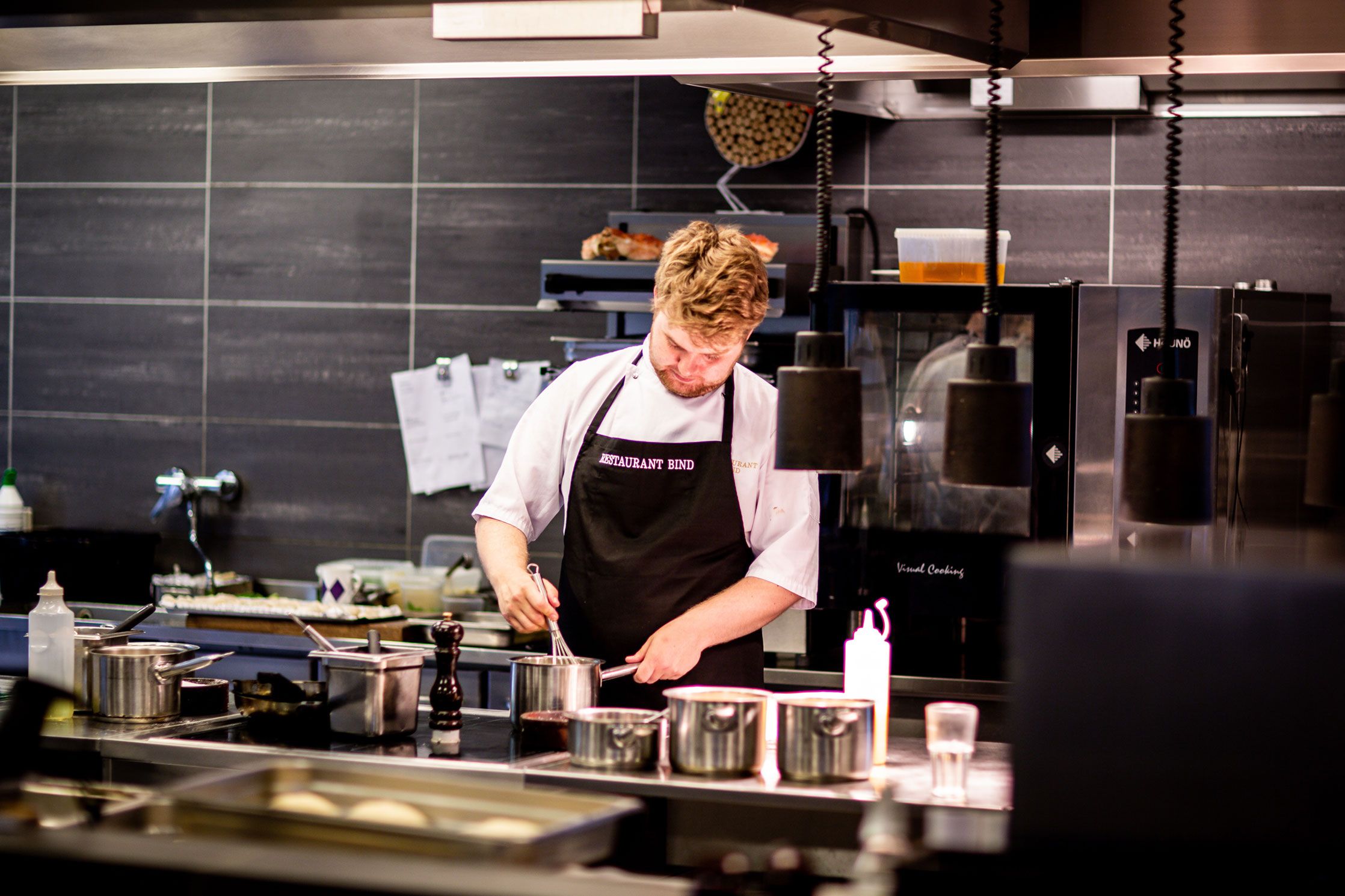 Commercial Maintenance A man is preparing food in a kitchen.