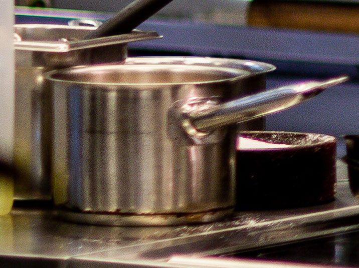 A silver pot with a lid on it.