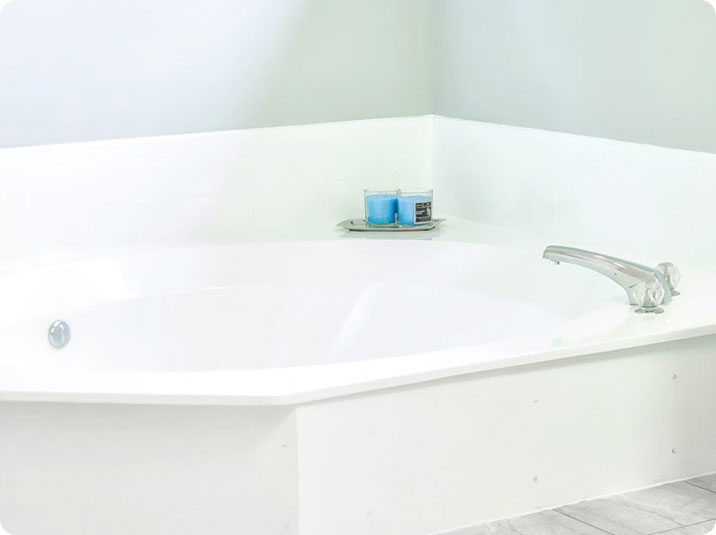 A white bathroom with a bathtub and a toilet.
