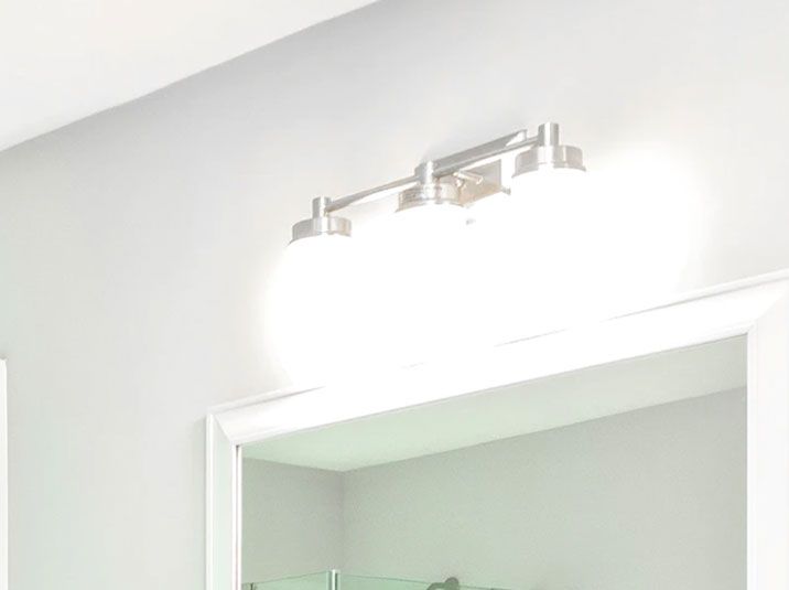 A bathroom with a mirror and light fixtures.