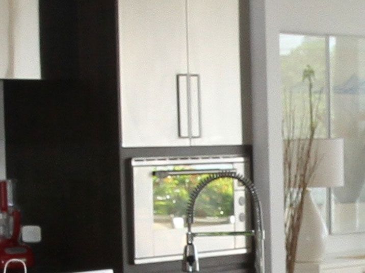 A kitchen with a stove and refrigerator.