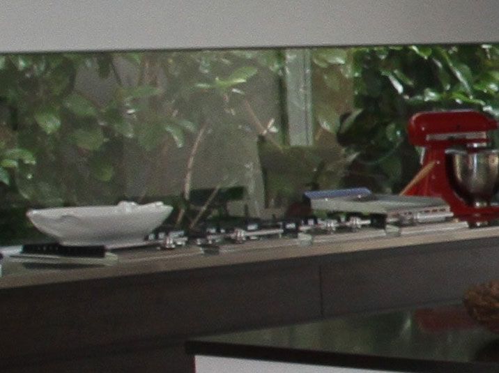 A kitchen with a red mixer.