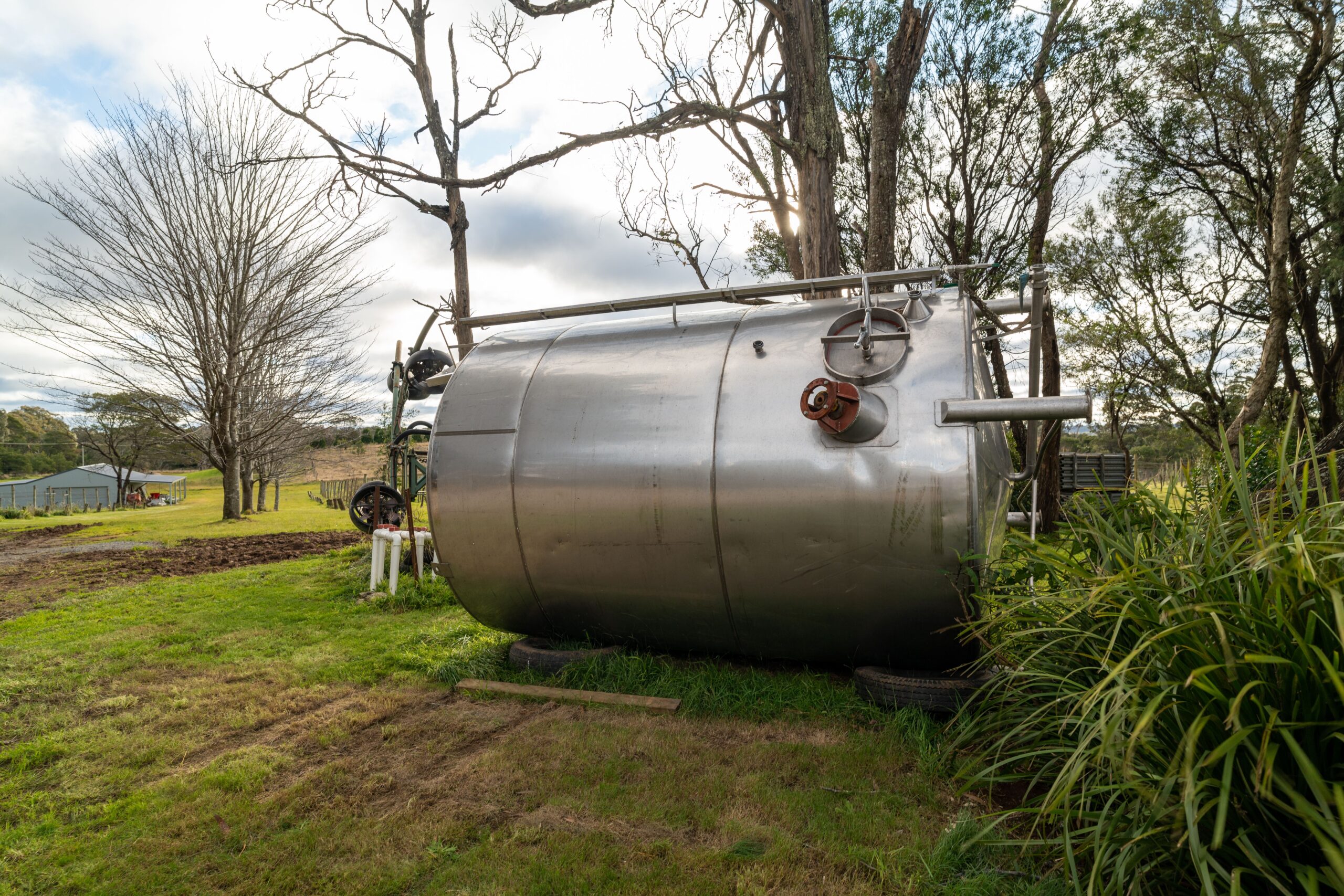 A large oil tank in residential backyard - ideal for removal by a professional like SM Brown.
